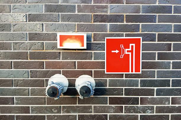 Fire risers. Branch pipes with connecting heads on the wall. For connecting hoses for extinguishing fire. Red plate instruction.