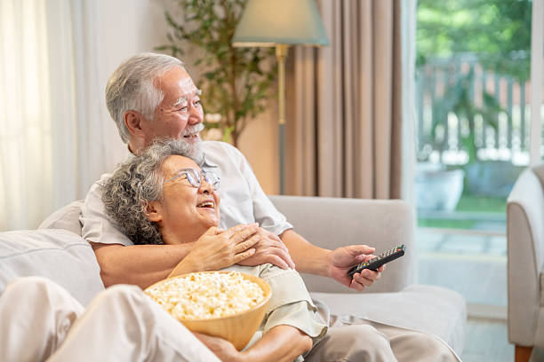 istock Asian senior couple relaxing together at home. 2235350310