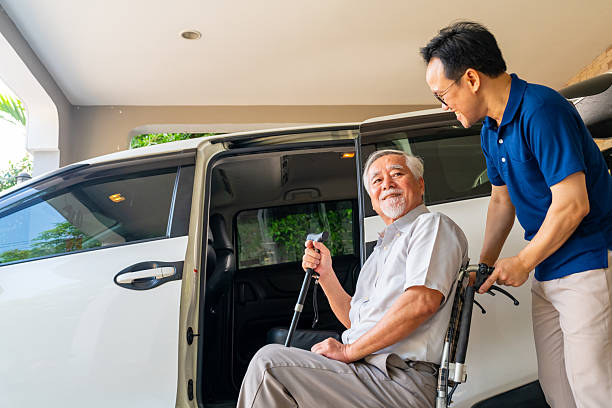 istock Caregiver helping senior man get in the car. 2235350353