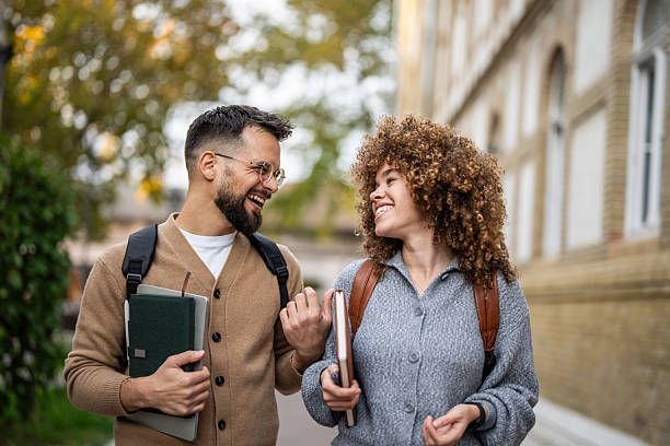 istock Cheerful university students walking and talking together on campus 2235351183