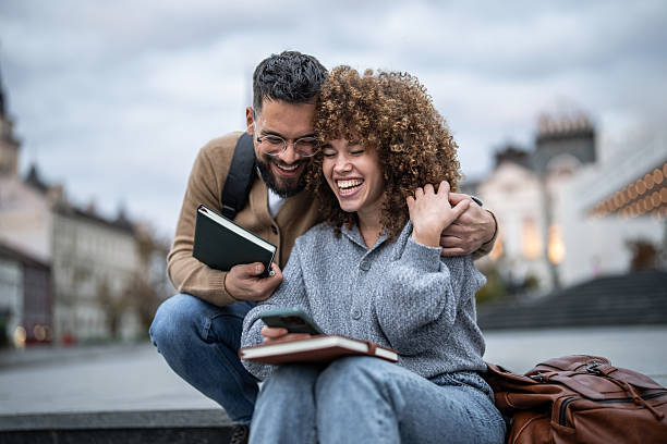 istock Students laughing together while studying outdoors in the city 2235351502