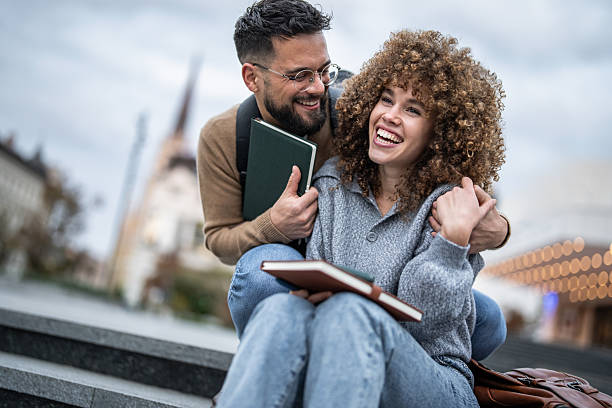 istock Happy students couple laughing together on university campus 2235351610