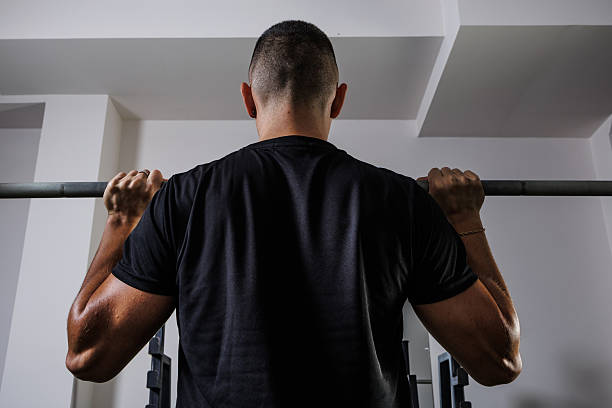istock Man Performing a Military Press Exercise in a Modern Gym Setting 2235352396