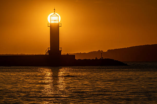 The sun aligns with the Museo do Mar Lighthouse in Vigo, Galicia, crowning the tower with radiant light and turning it into a symbolic temple of the day on the Atlantic coast of Spain.