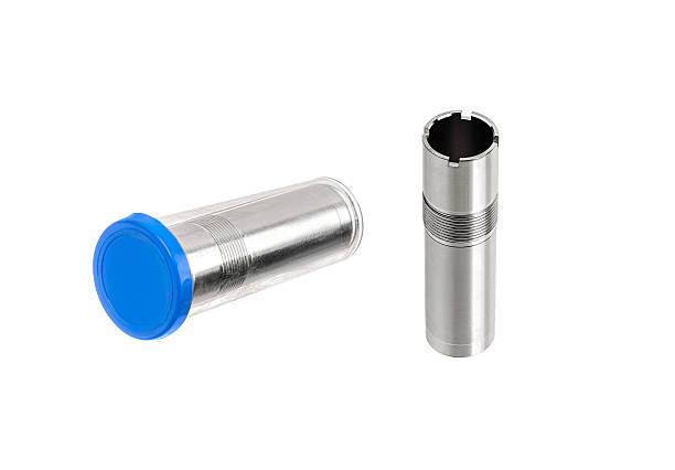istock Two shiny metallic shotgun choke tubes on a white background. 2235354119