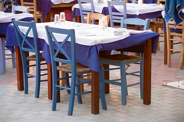 Street at Ithaki island with table and chairs of tavern, Ionian Sea, Greece