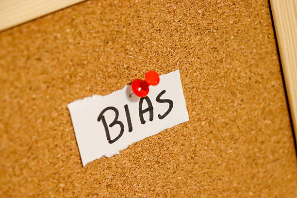 istock A handwritten note displaying the word BIAS pinned to a corkboard. This image conveys concepts related to perception, judgment, and personal perspectives, suitable for editorial use. 2235358519