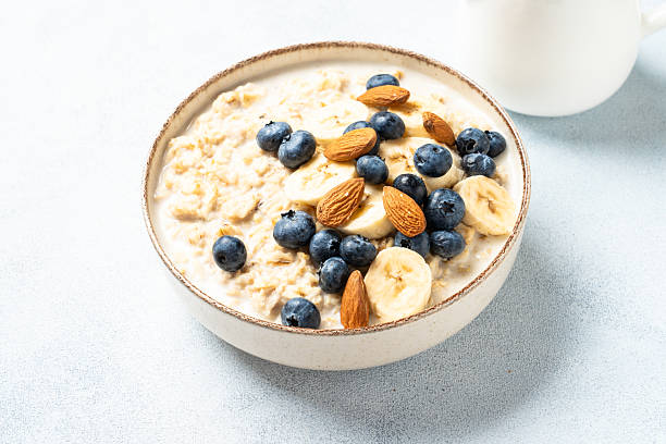 istock Oatmeal porridge with bananas, nuts and blueberries. 2235358883