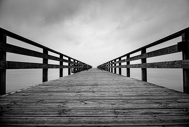 istock Black and White Pier with Leading Lines to the Horizon 2235360194