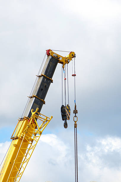 istock yellow crane boom against sky background, copy space 2235360487