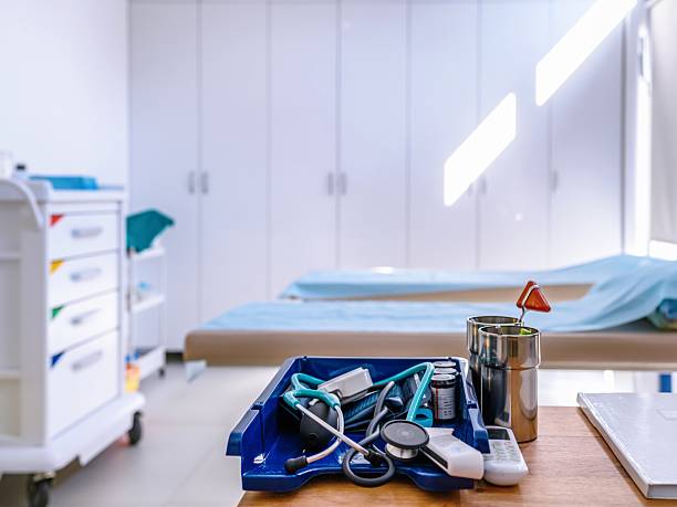Travel medical insurance concept. Red stethoscope and pink and blue travel suitcases on blue background.