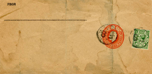 A piece of dirty brown water-stained paper from a parcel with one red printed postage stamp and one green adhesive postage stamp, both postmarked but unreadable. The total postage is a penny halfpenny and the monarch is King George V. (Name and address removed.)