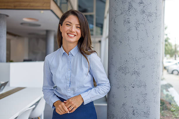 istock Young businesswoman smiling in modern office building 2235371249
