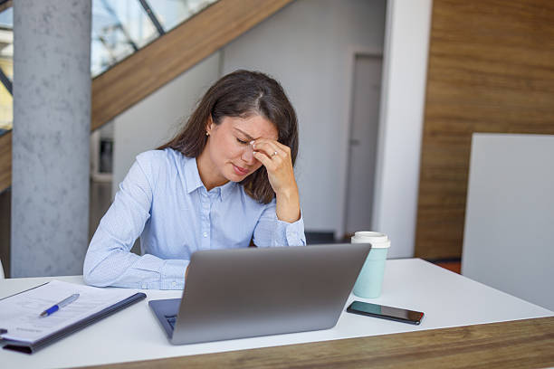 istock Stressed businesswoman suffering from headache at work 2235371290