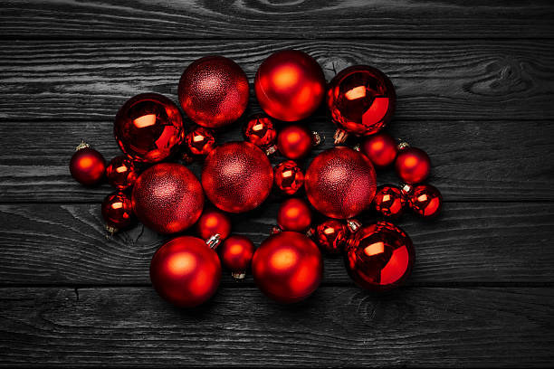 istock red christmas balls on dark wooden table 2235372314
