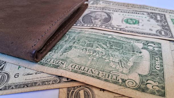 istock Leather wallet and us dollar bills 2235372762