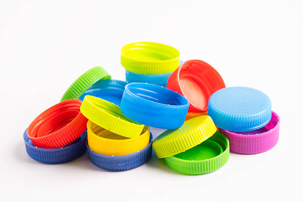 Plastic caps. Yellow plastic caps. Recycling of plastic. Selective soft focus