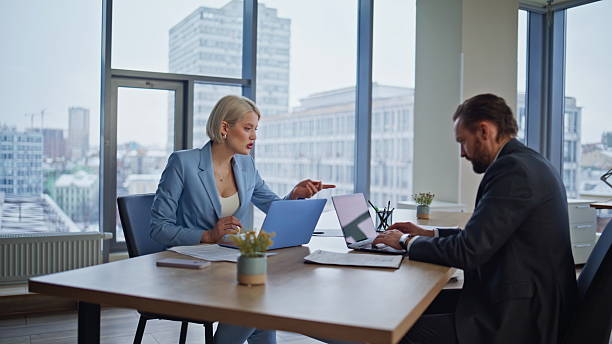 istock Two partners typing laptops sitting office closeup. Startup winners giving five 2235377048