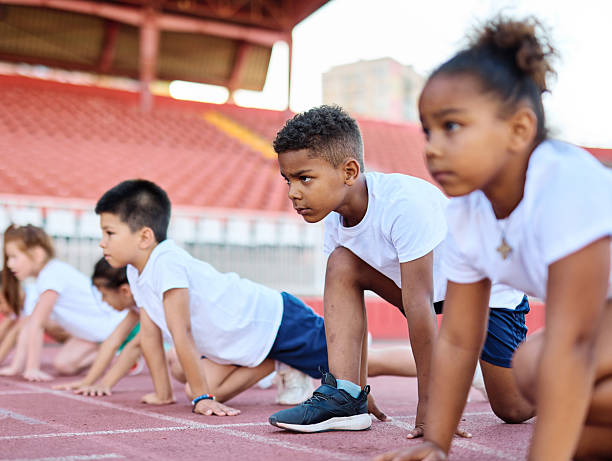 child sport athlete competition running exercise sprinting line start race runner preparation success concentration starting sprinter competitive finish winner