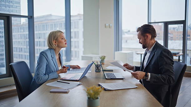 istock Focused employees reviewing paperwork at workspace closeup. Smiling accountants 2235379836