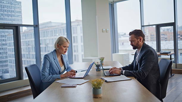 istock Anxious coworkers discovering error feeling frustrated in corporate building 2235380353