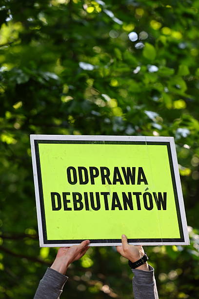 istock Sign Held Up Polish Text 'debutants' briefing' Against Greenery during parkrun event 2235382101