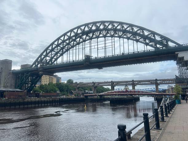 Newcastle United Kingdom panoramic view of the river Tyne with the iconic Tyne Bridge and a small yacht in the foreground