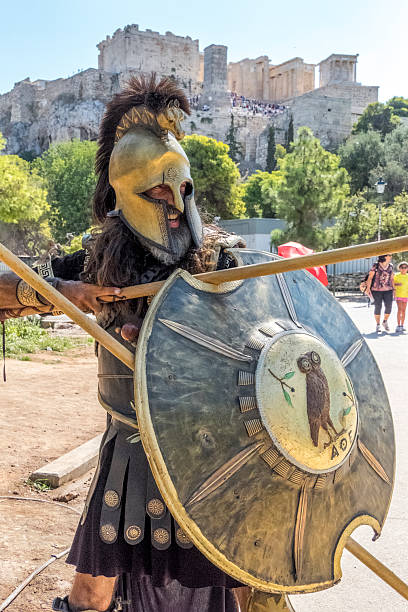 Attica, Greece - September 04, 2025: Man dressed as a Greek warrior and Acropolis in Athens