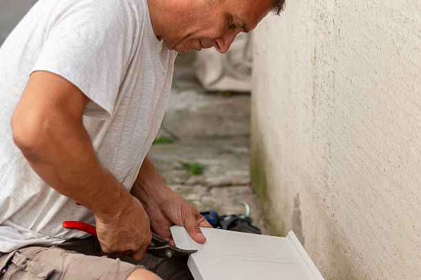 istock A craftsman preparing metal sill for external PVC window frame. The process of preparing and cutting window sills. 2235385355