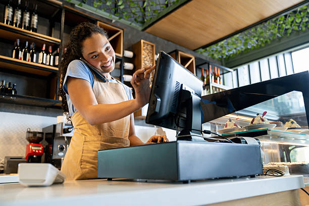 istock Waitress talking on the phone taking a delivery order at a cafe 2235389297