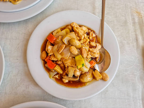 Enjoy a close-up view of tender chicken pieces drenched in a rich sauce, perfect for any meal, event, or culinary experience showcasing delicious flavors.