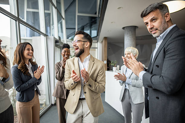 istock Happy business team clapping and celebrating success in office 2235400404