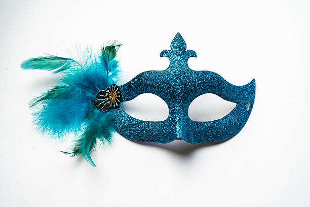 Sparkling blue carnival mask decorated with glitter and feathers isolated on white background used for halloween and masquerade parties.