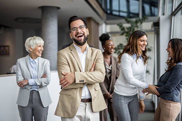 istock Happy business team laughing together in modern office 2235402008