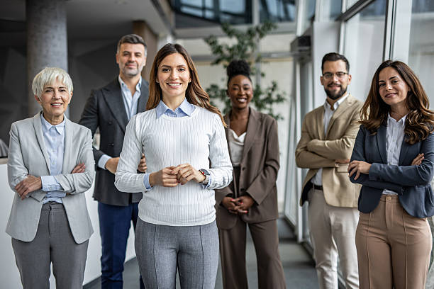 istock Smiling business team posing together in modern office 2235402120