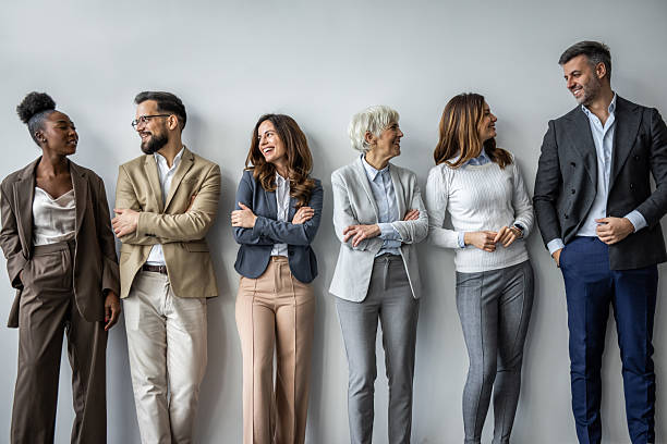 istock Diverse business team leaning against wall and talking 2235402209