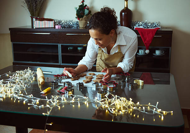 istock Woman Decorating Christmas Cookies in a Festive Kitchen Setting 2235404873