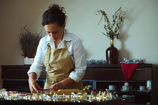 istock Woman Baking and Decorating Christmas Cookies in a Festive Kitchen 2235404882