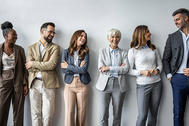 istock Diverse business team smiling with arms crossed against wall 2235405122