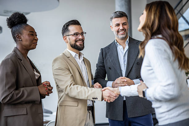 istock Business people shaking hands in modern office 2235405505