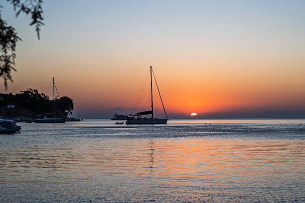 Sailboat on calm bay at sunset, Leros, Greek Islands