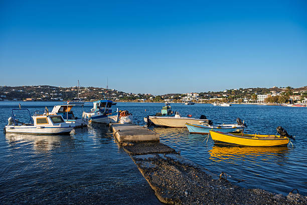 View across dock with boats to village and hills, Leros, Greek Islands