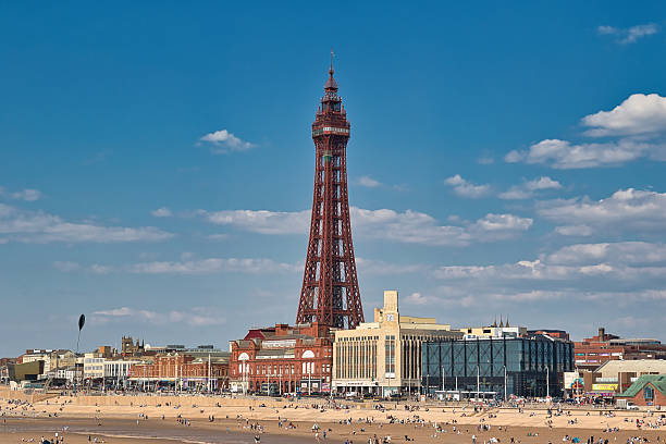 istock Blackpool Tower, Buildings, and Beach with People Under a Blue Sky 2235407513