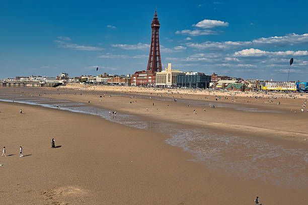 istock Blackpool Tower and Beach with People Under Partly Cloudy Sky 2235407534