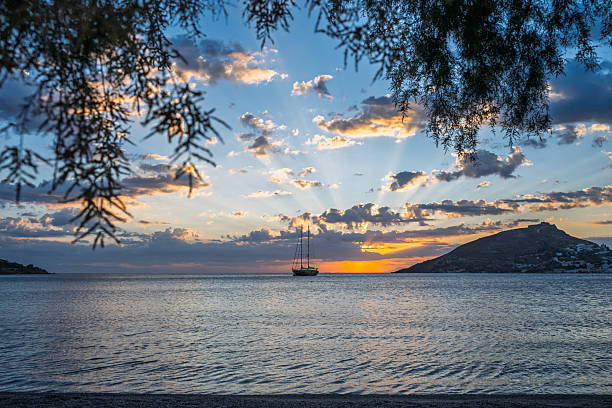 Sailboat on calm bay at sunset, Leros, Greek Islands