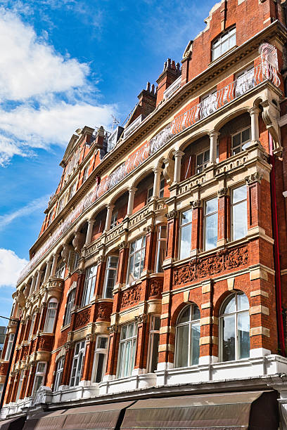 istock Red brick building with arched windows and decorative elements under blue sky  in London, UK. 2235408298