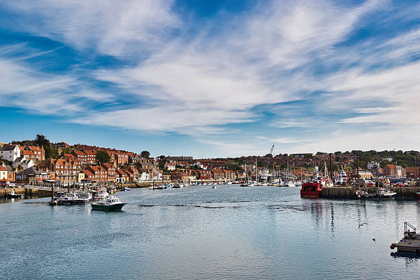 istock Harbor with Boats and Townscape Under a Cloudy Sky  in Whitby, UK. 2235409552