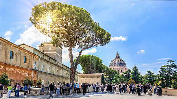 Tourists visit the Fontana della Pigna, a former Roman fountain which now decorates a niche in the wall of the Vatican in Vatican City, Rome, home of the Pope.