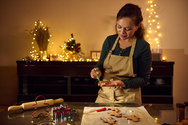 istock Woman Decorating Gingerbread Cookies in a Festive Christmas Kitchen Setting 2235409937
