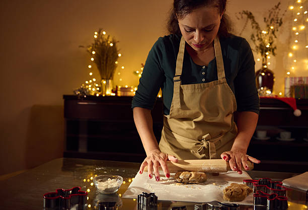 istock Woman Rolling Dough for Cookies in a Festive Holiday Setting 2235410121